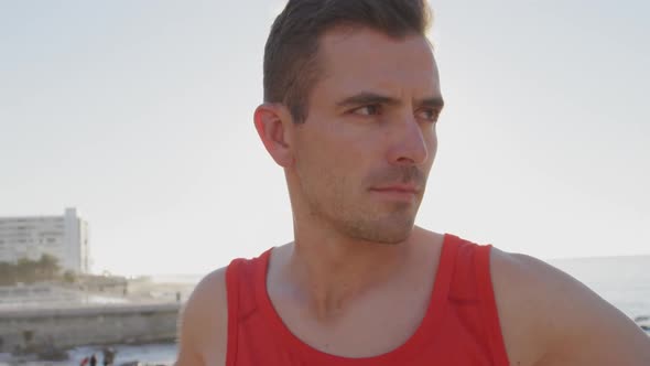 Young man exercising by the sea