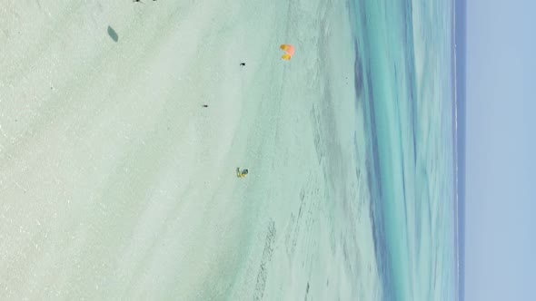 Zanzibar Tanzania  Vertical Video Kitesurfing Near the Shore of Ocean Slow Motion