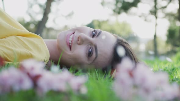 Smiling woman lying on the grass