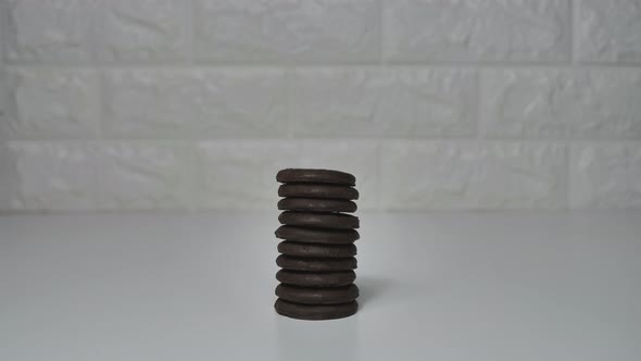 A stack of chocolate chip cookies sprout on a white table