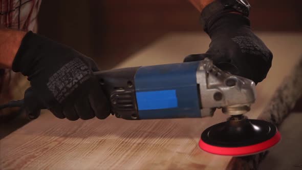 Man Using Grinding Machine in a Garage.