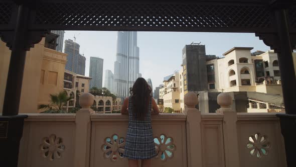 Woman Enjoying a View of Burj Khalifa in Dubai From the Balcony