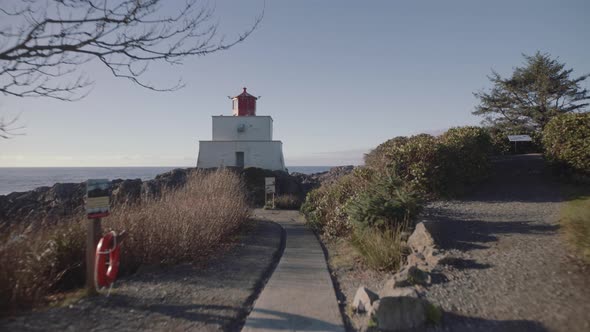 Wide fast moving towards Amphitrite point lighthouse on sunny day in Ucluelet, Vancouver Island, Can