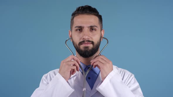 Young Male Doctor with Stethoscope Posing