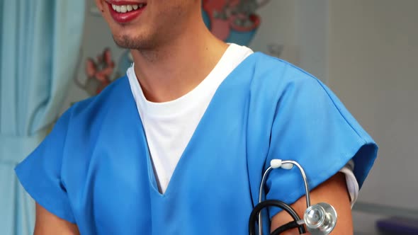 Doctor standing with arms crossed in hospital