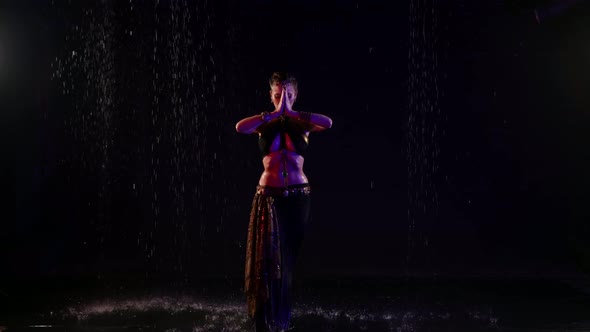 Belly Dance Under Rain at Night Sexy Female Dancer is Moving in Darkness Fulllength Portrait