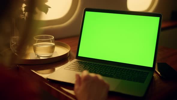 Woman Watch Green Laptop Screen on First Class Flight