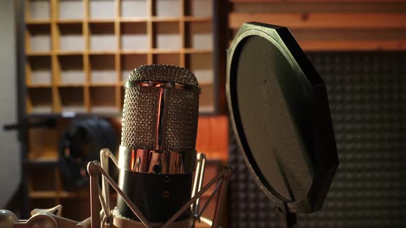 Sound studio microphone in audio production studio. A microphone in studio awaits the singer.