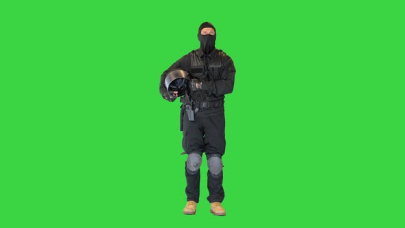 Riot Policeman Standing Holding His Helmet in Hands on a Green Screen Chroma Key