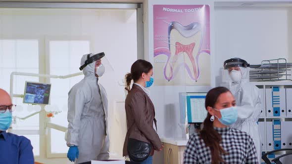 People with Protection Mask Sitting in Waiting Area