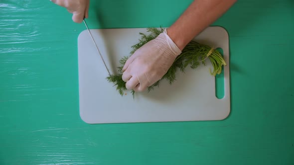 Chef Cook Cutting Dill on a White Board