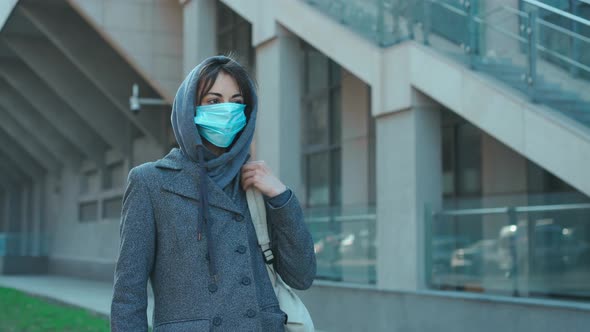 Woman in Face Mask for Protection Coronavirus Walking on City Street