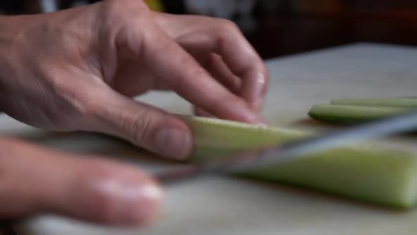 Close Up View of Removing Inedible Parts and Cutting Cucumber Into Thin Slices