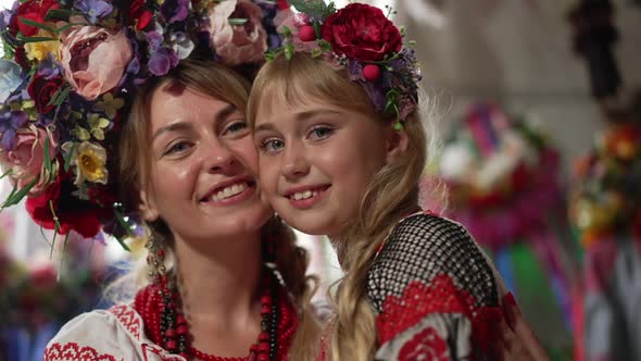 Closeup Charming Girl Smiling Looking at Camera As Beautiful Woman Hugging Child