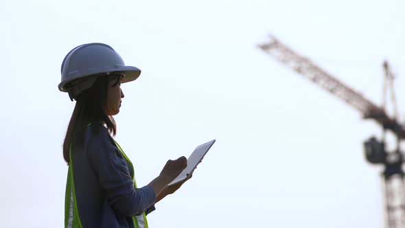 Female civil Engineering working with tablet on construction site