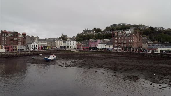 Flying Over a Bay Towards the Town of Oban in Scotland