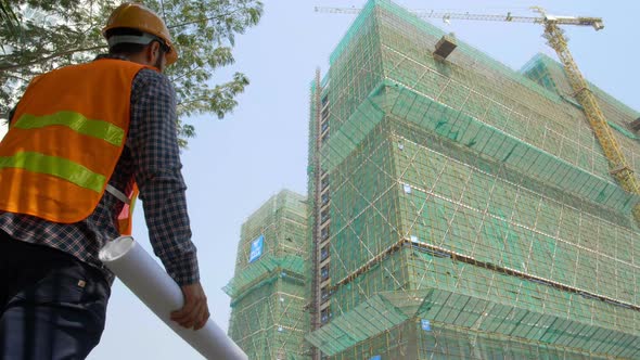 Engineer Looking at Constructing Building alt