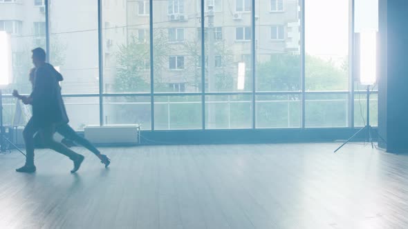 A Young Man and Woman in a Dance Studio Practicing New Moves