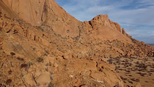 Drone span along the side of a rocky mountain Erongo in Namibia, desert