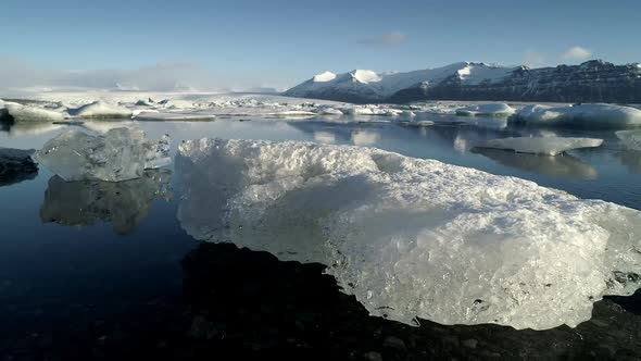 Flying Above Floating Icebergs. Ice From Glacier Crystal Shining. Ice Lagoon Global Warming Explore