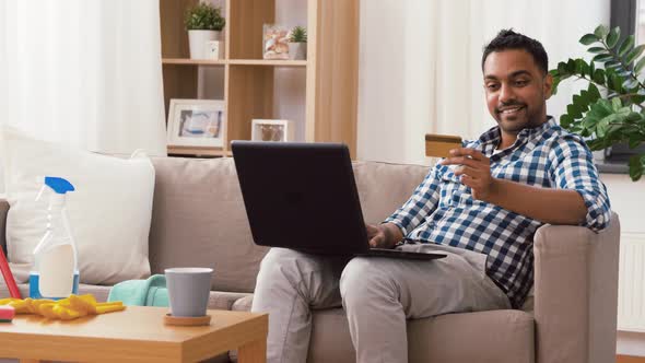 Man with Laptop Shopping Online After Cleaning 80