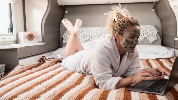 Beauty mask skin care age cream treatment adult caucasian woman laying inside a camper van.