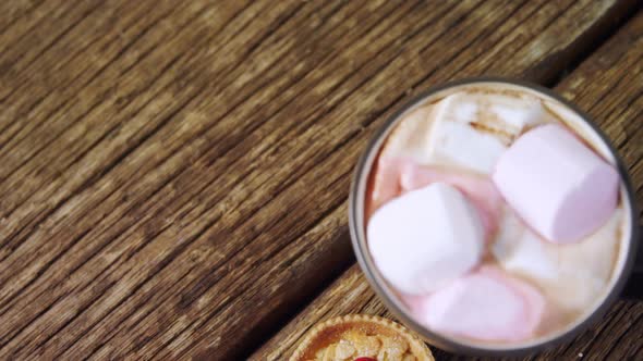 Cookies and hot chocolate on wooden plank