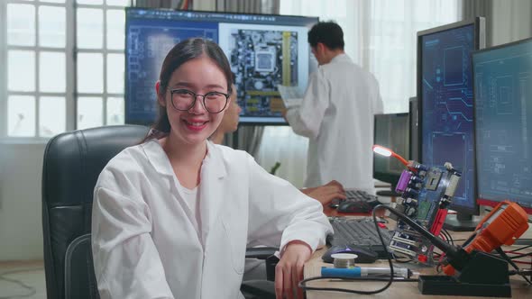 Modern Electronics Development Facility:  Asian Woman Smiling Charmingly Looking At Camera