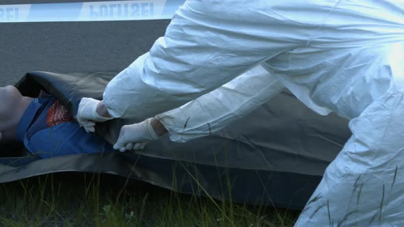 Coroner Zip Dead Man into Body Bag