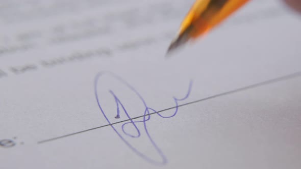 Closeup of a Man Signing a Settlement Agreement a Contract or an Agreement on Hiring and Hiring