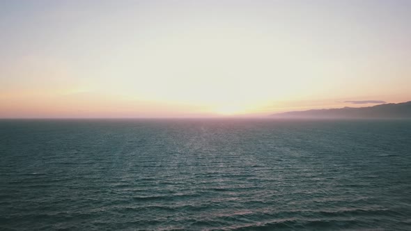 Drone shot of sunset over pacific ocean at Venice beach Los Angeles