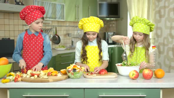 Three Kids Making Salad.