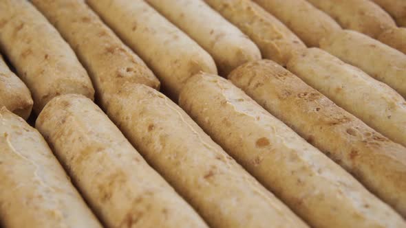 Baked round crackers salty sticks close-up stacked in rows