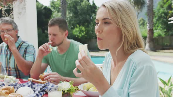 Happy family eating together at table