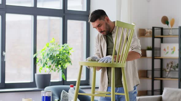 Man with Rag Cleaning Old Chair for Renovation