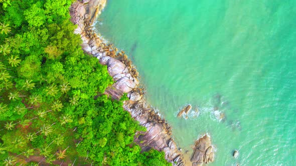 Aerial Top views over beaches, ocean waves crashing on rocks and sand