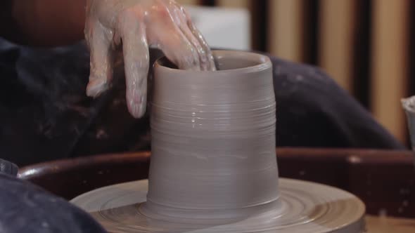 Pottery  Wetting the Piece of Clay on the Pottery Wheel