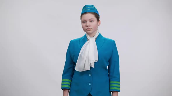 Confident Future Stewardess Saluting and Smiling Looking at Camera