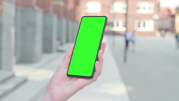 Woman Looking at Smartphone with Green Chroma Screen