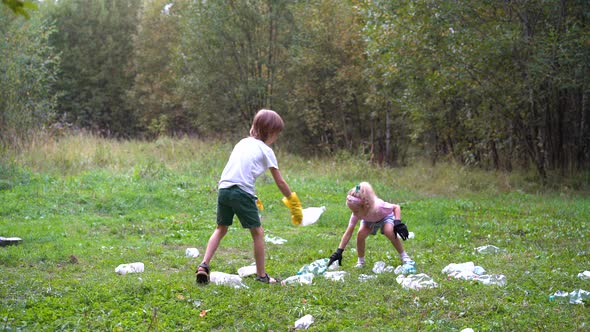 Children Remove Plastic Garbage and Put It in a Biodegradable Garbage Bag in the Open Air