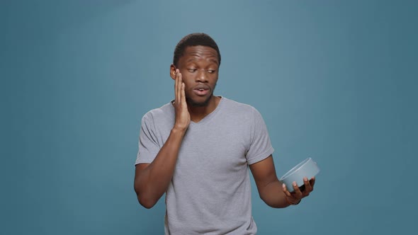 Stressed Man Checking Time on Wall Clock and Running Late to Work