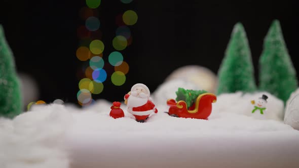 Toy Santa Claus and Snowman on a Christmas Background