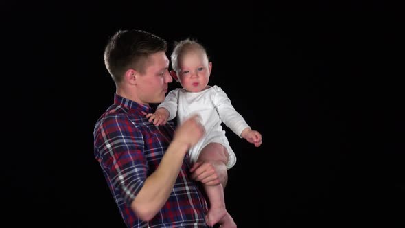 Father and Baby Girl Playing Together. Black