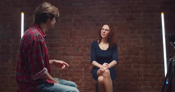 Team of Reporters Working on Interview with Young Businesswoman in Studio