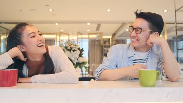 Happiness asian couple laugh smile together with in kitchen pantry