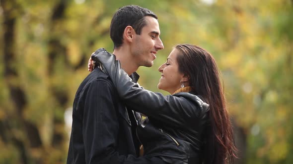 Video of young coupe kissing in the autumn park