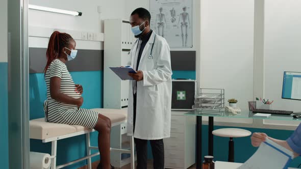 African American Medic and Pregnant Patient Meeting at Appointment