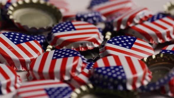 Rotating shot of bottle caps with the American flag printed on them - BOTTLE CAPS 