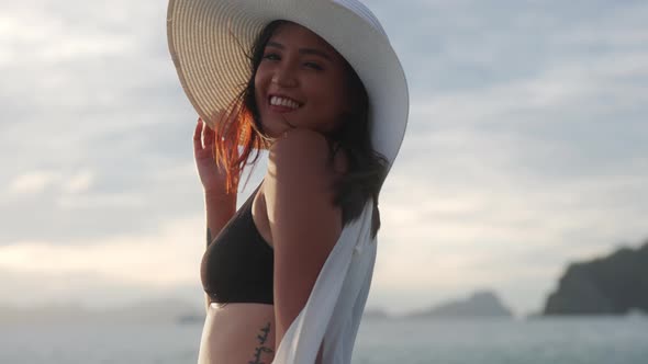 Woman In Sun Hat And Bikini Smiling To Camera