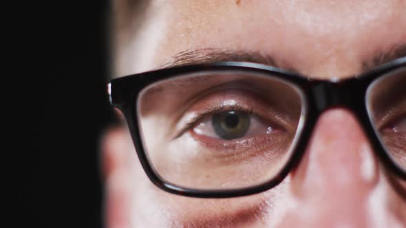 Close up portrait of face of caucasian man wearing glasses with focus on eye